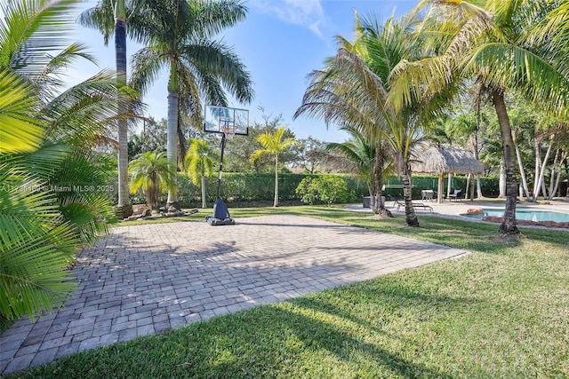 surrounding community with a gazebo, a yard, and a swimming pool