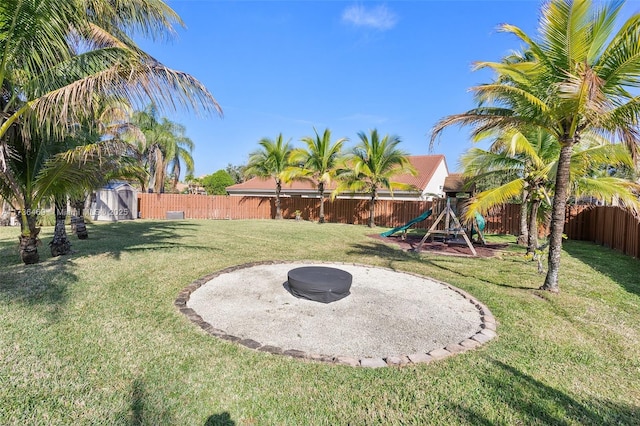 view of yard featuring a playground and a storage unit