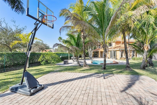 exterior space featuring a fenced in pool, a yard, and a patio area