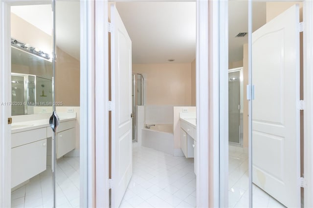 bathroom with vanity, shower with separate bathtub, and tile patterned floors