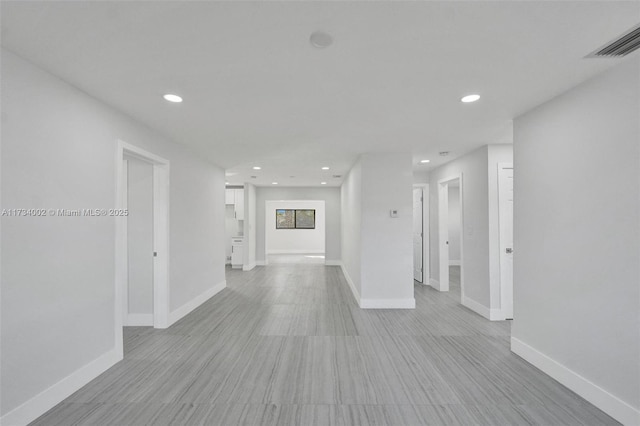 hallway with light hardwood / wood-style flooring