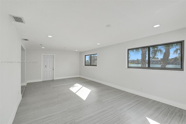 empty room with light hardwood / wood-style flooring