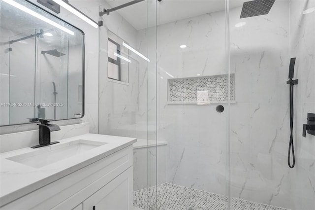 bathroom with vanity and a shower with shower door