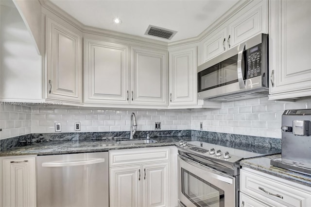 kitchen featuring sink, white cabinets, and appliances with stainless steel finishes