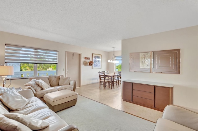 living room with light tile patterned flooring and a textured ceiling