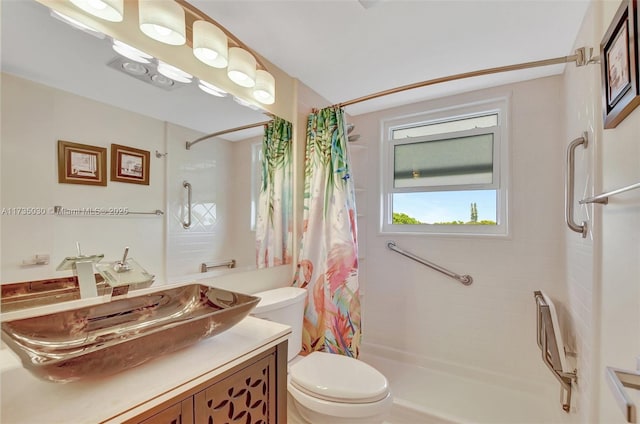 bathroom with vanity, toilet, and curtained shower