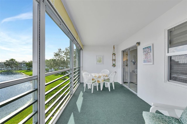 sunroom featuring a healthy amount of sunlight and a water view