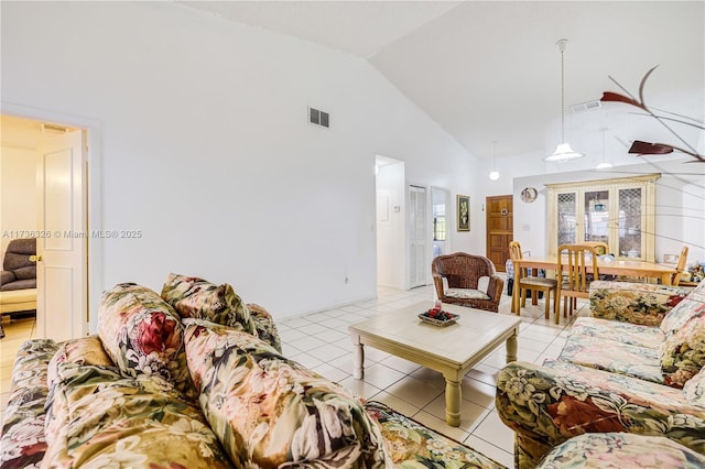 tiled living room with high vaulted ceiling