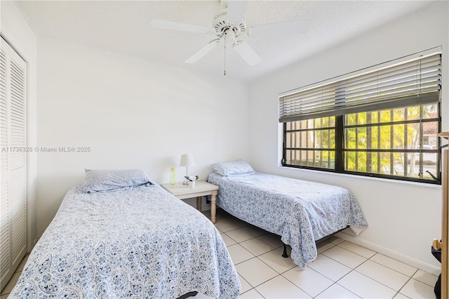 bedroom featuring light tile patterned floors and ceiling fan