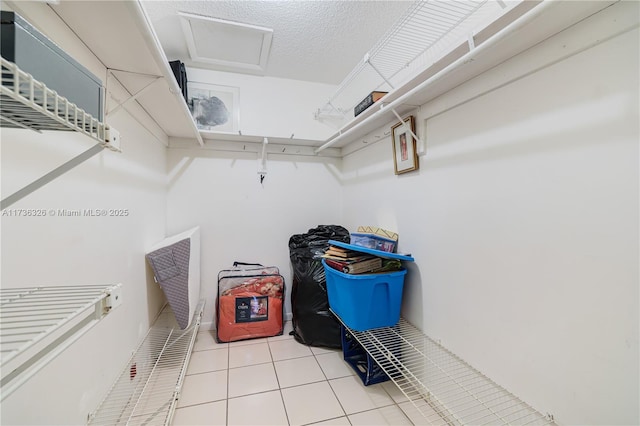 walk in closet featuring light tile patterned flooring