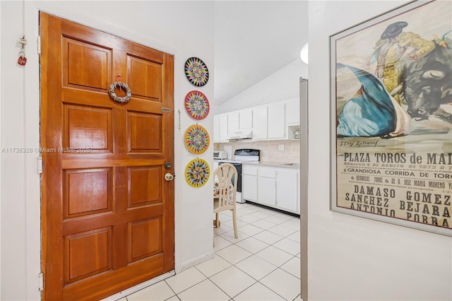 interior space featuring light tile patterned flooring and cabinets