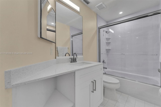 full bathroom featuring tile patterned flooring, enclosed tub / shower combo, vanity, and toilet