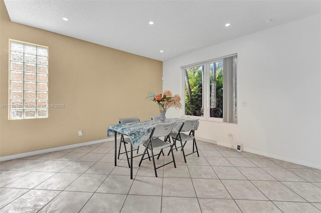 tiled dining room with a textured ceiling