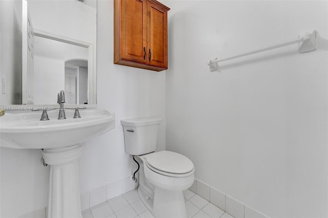 bathroom featuring sink, toilet, and tile patterned flooring