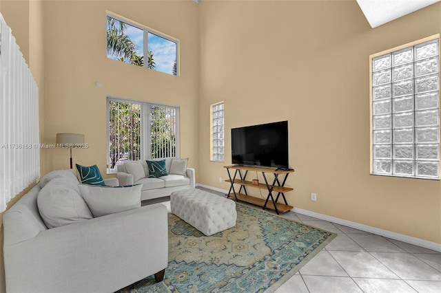 tiled living room featuring a towering ceiling