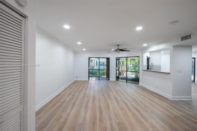 spare room with crown molding, sink, ceiling fan, and light hardwood / wood-style flooring