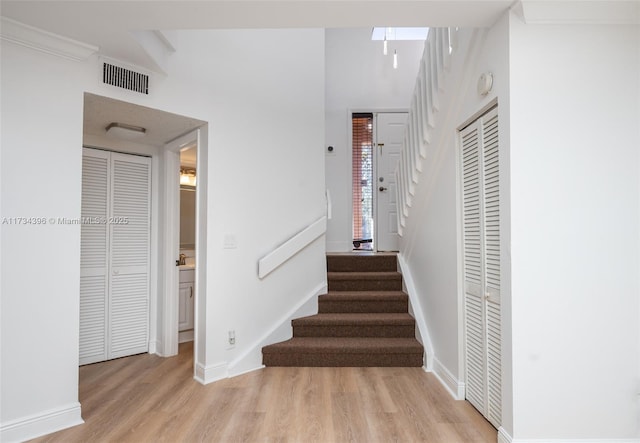 staircase with hardwood / wood-style floors