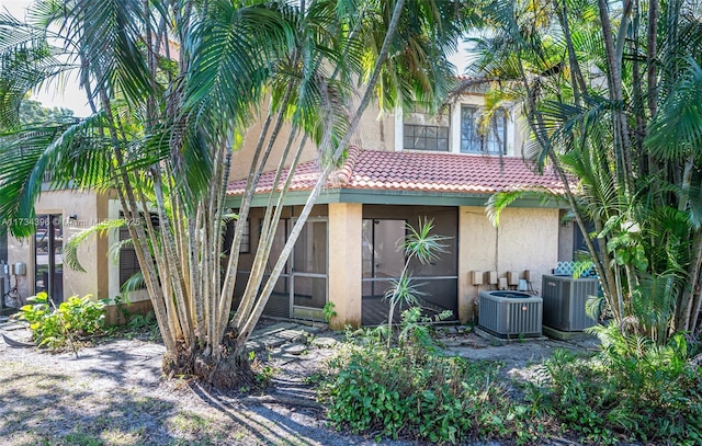 rear view of property with cooling unit