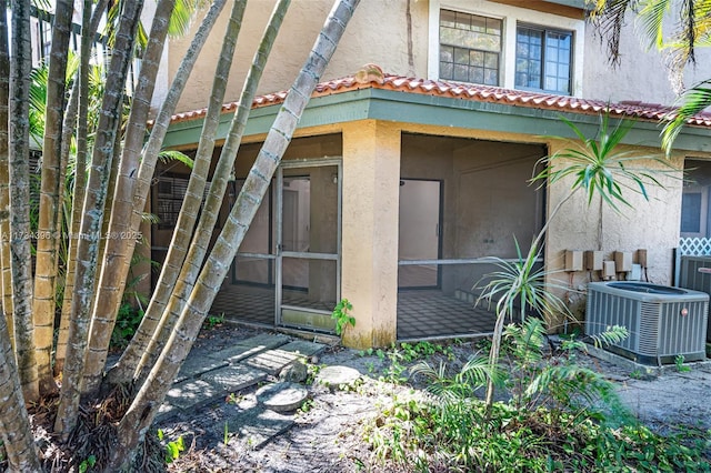 exterior space featuring a sunroom and cooling unit