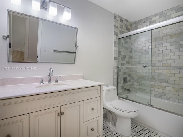 full bathroom featuring enclosed tub / shower combo, vanity, and toilet