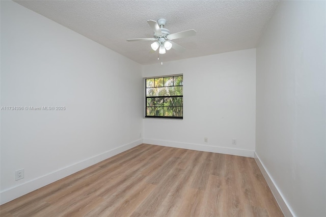 spare room featuring ceiling fan, a textured ceiling, and light hardwood / wood-style floors