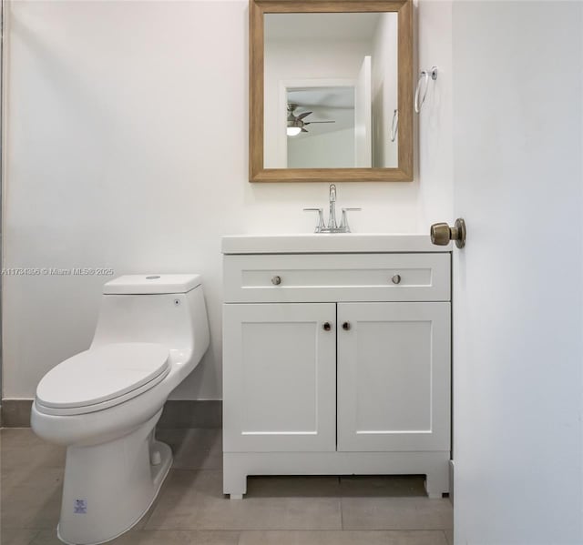 bathroom with vanity, tile patterned floors, and toilet