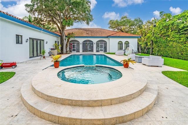 view of swimming pool with an in ground hot tub, an outdoor living space, and a patio