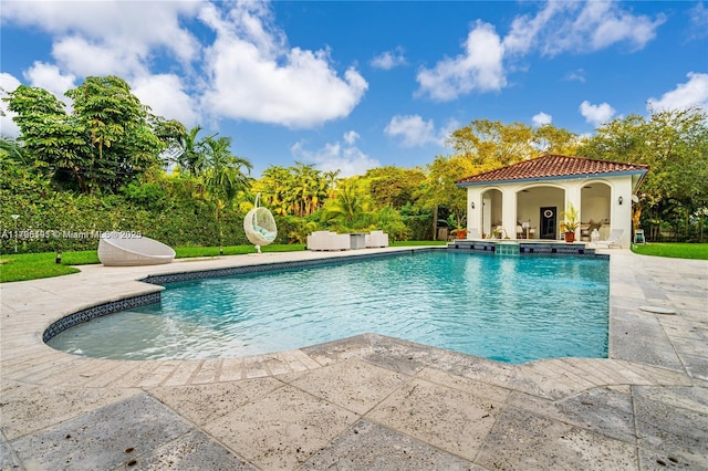 view of pool with an outbuilding and a patio area