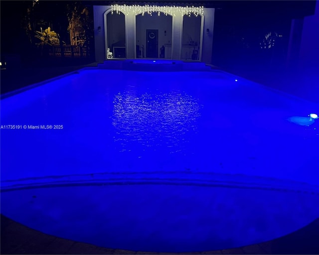 view of pool at night