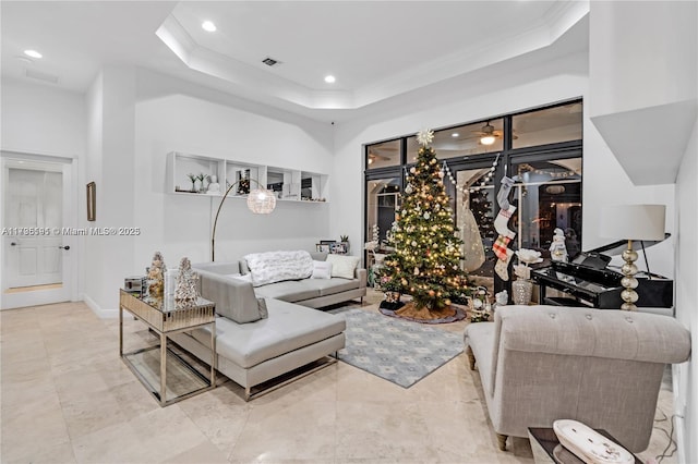 living room with crown molding and a raised ceiling