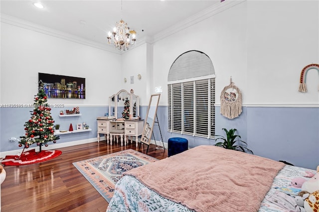 bedroom featuring hardwood / wood-style flooring, ornamental molding, and a notable chandelier