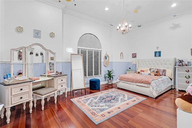 bedroom featuring crown molding, dark hardwood / wood-style floors, and a notable chandelier