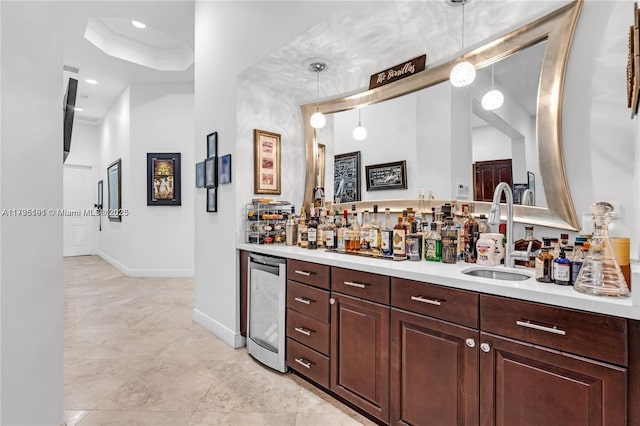 interior space with wine cooler, ornamental molding, sink, and hanging light fixtures