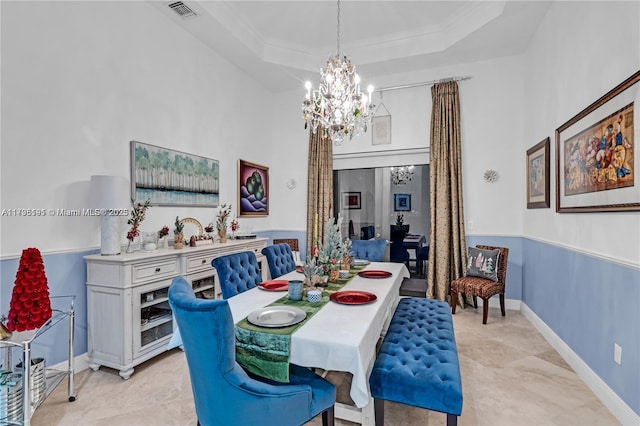 dining area featuring a raised ceiling, crown molding, a high ceiling, and a notable chandelier