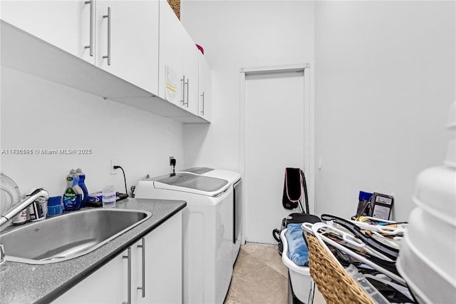 clothes washing area featuring cabinets, washer and dryer, sink, and light tile patterned floors