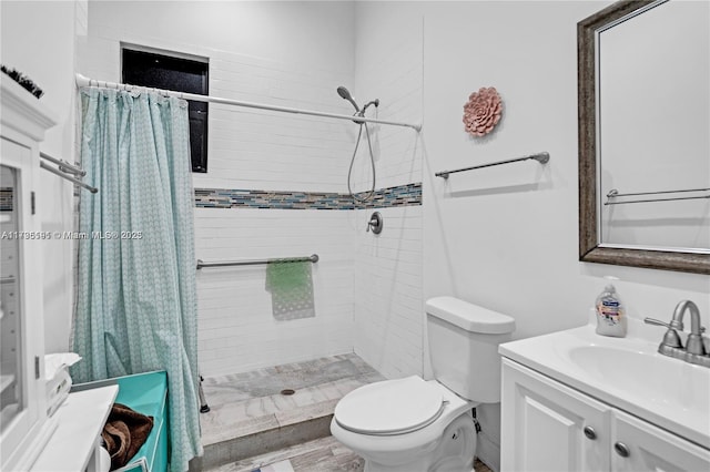 bathroom with vanity, toilet, and curtained shower