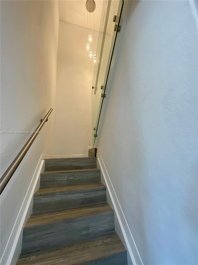 stairs with hardwood / wood-style floors