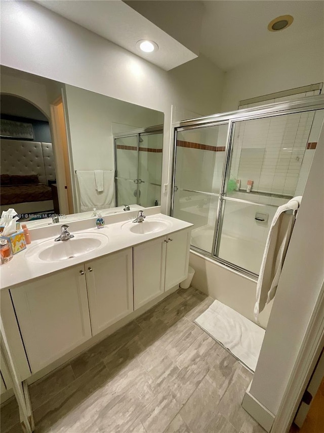 bathroom featuring vanity and combined bath / shower with glass door