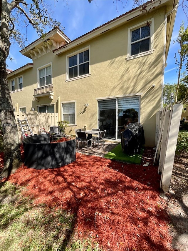 rear view of property featuring a patio area