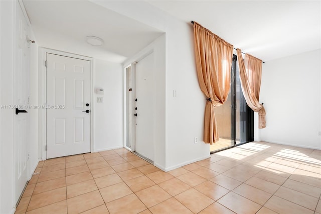 tiled foyer with a healthy amount of sunlight