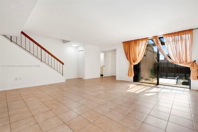 unfurnished living room with light tile patterned flooring