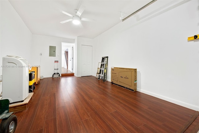 misc room featuring dark wood-type flooring, electric panel, and ceiling fan