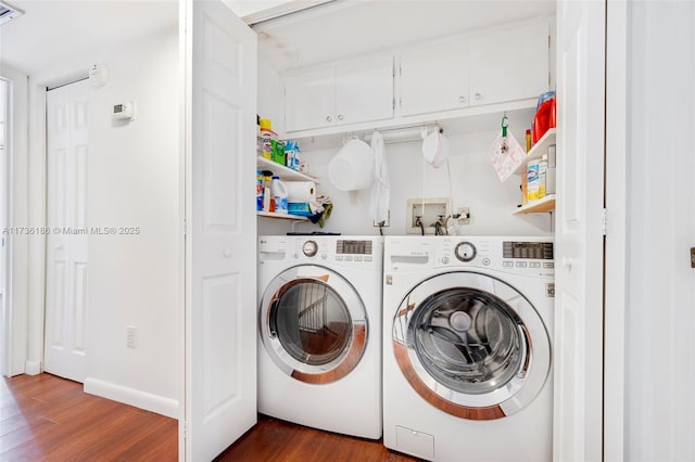 clothes washing area featuring dark hardwood / wood-style flooring and independent washer and dryer