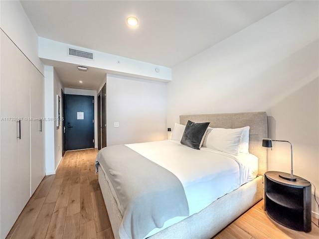 bedroom featuring a closet and light wood-type flooring