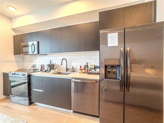 kitchen with tasteful backsplash, sink, and stainless steel appliances