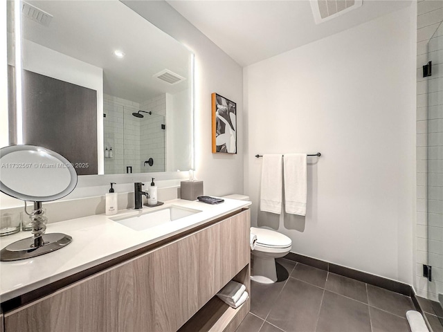 bathroom with tile patterned floors, toilet, an enclosed shower, and vanity