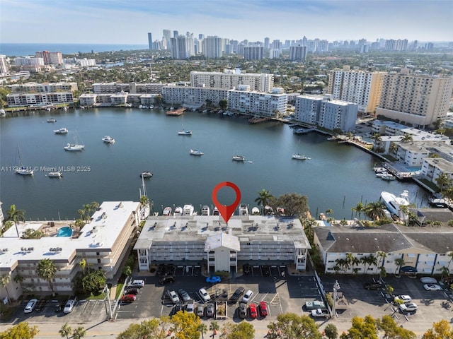 birds eye view of property featuring a view of city and a water view