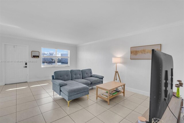 living room with light tile patterned flooring, baseboards, and ornamental molding