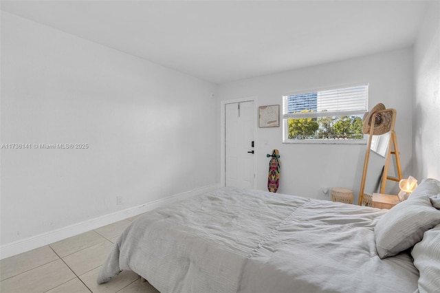 bedroom with tile patterned floors and baseboards