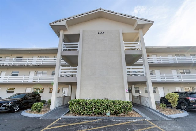 view of building exterior with uncovered parking